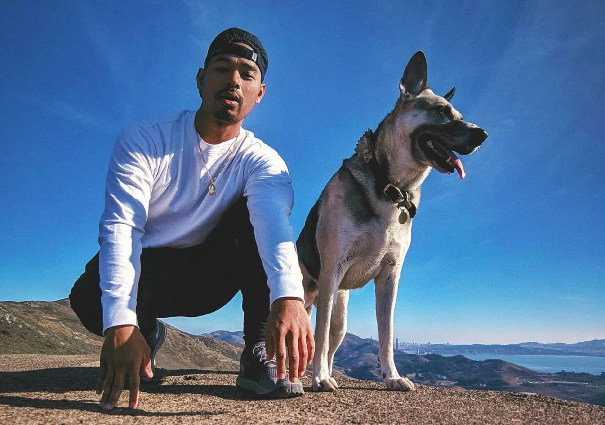 Ratha Nou, founder of Stablished Projects, with Coalla (RIP) — his German Shepherd / Husky dog and brand mascot